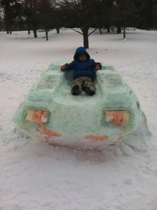 Roan age 5, on top of snow car. Photo by Johanna Romain