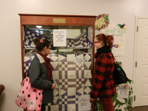 Students admire quilt created by Rene Parson and "The Seam Rippers."  Photo by Jenna Kauffman